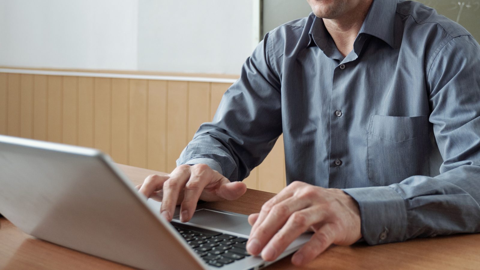 A financial advisor working on a laptop at a desk.