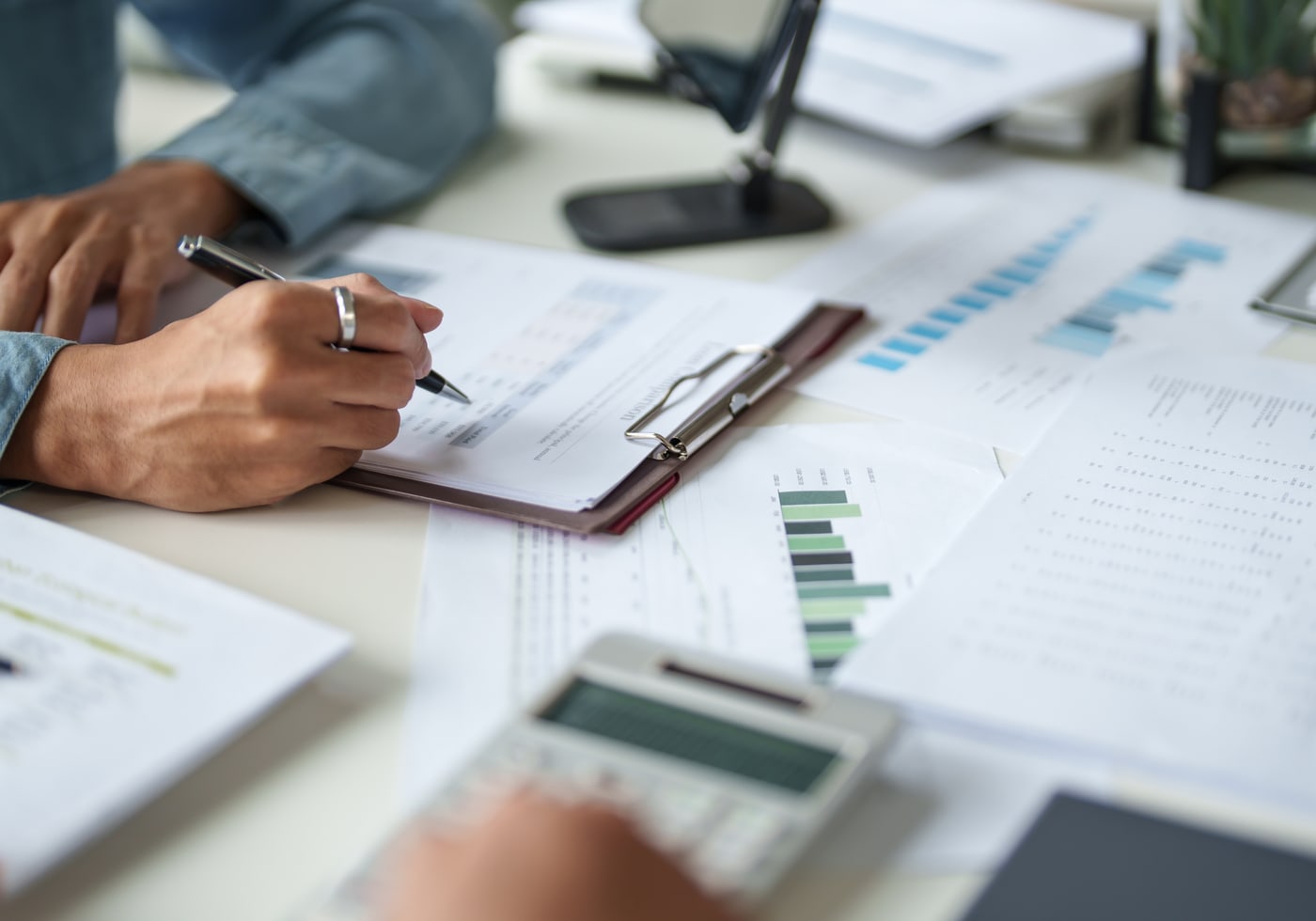 An advisor reviewing financial figures and portfolio reports.
